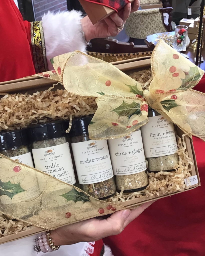 A holiday gift basket wrapped with a festive ribbon.