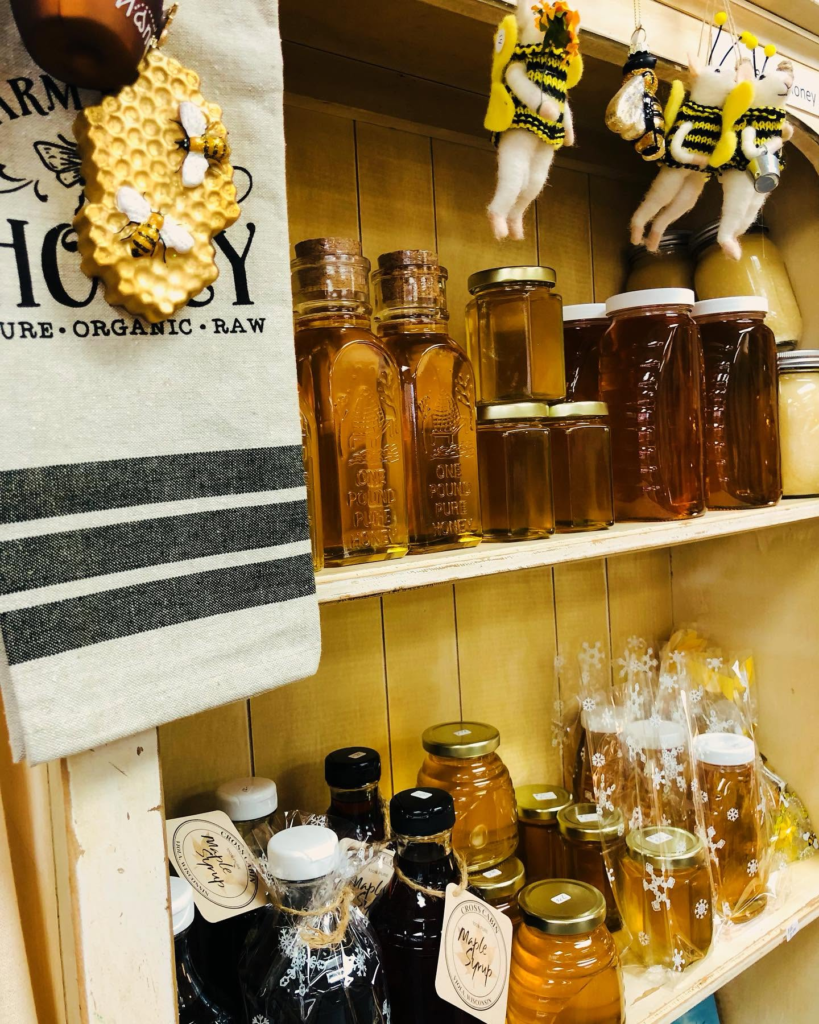 Jars of local honey on the shelf at Blue Heron Antiques.