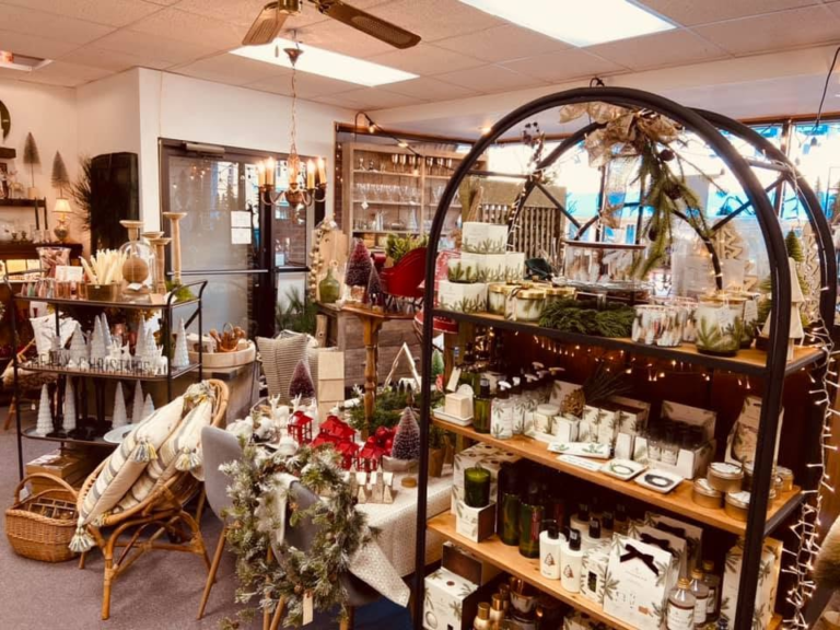 A downtown shop decorated for the holidays with gifts and garland.