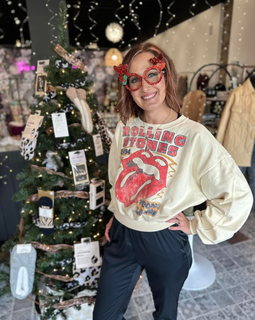 A shopper in a boutique decorated for the holidays.