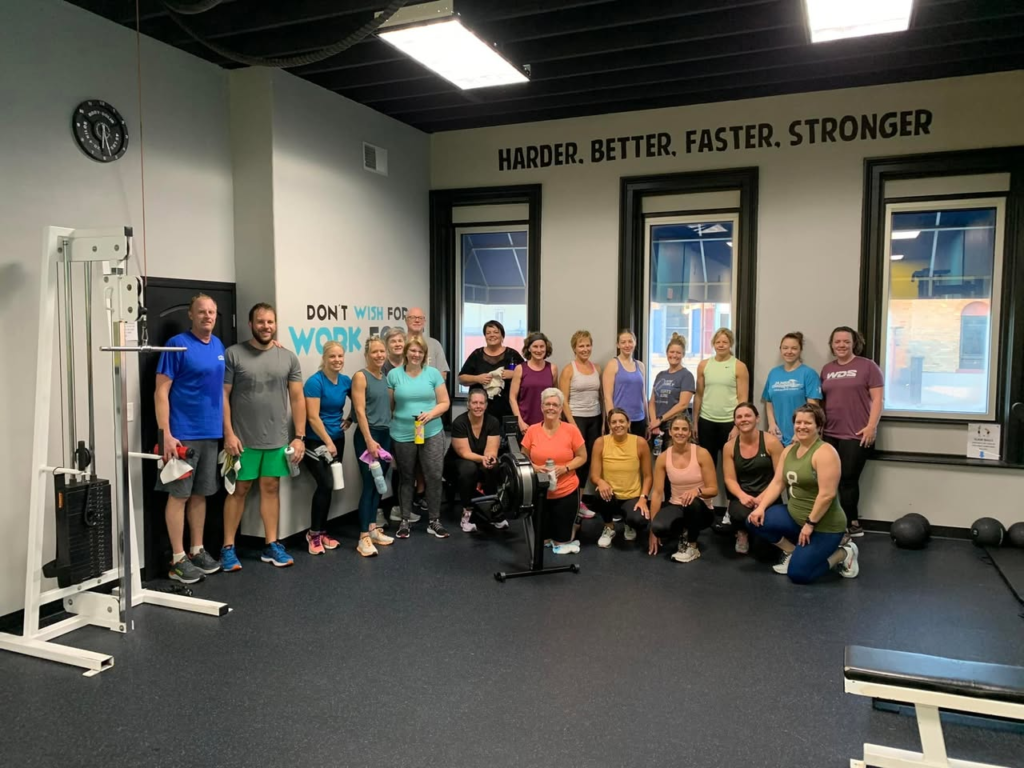 A group fitness class smiling together at Club Fitness.