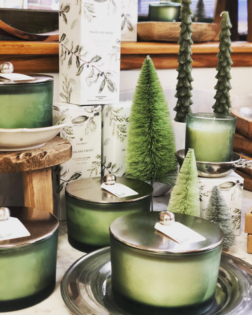 Bottlebrush trees and candles in a holiday display.
