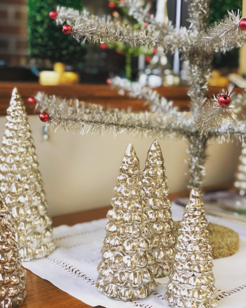 Silver tinsel trees sparkling in a holiday display.