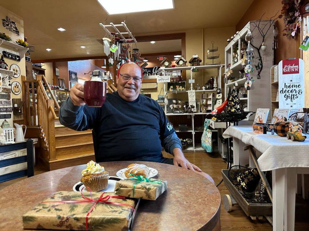 A smiling customer enjoying coffee at Guth’s Candy.