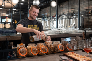 A bartender pouring a fresh draft beer.