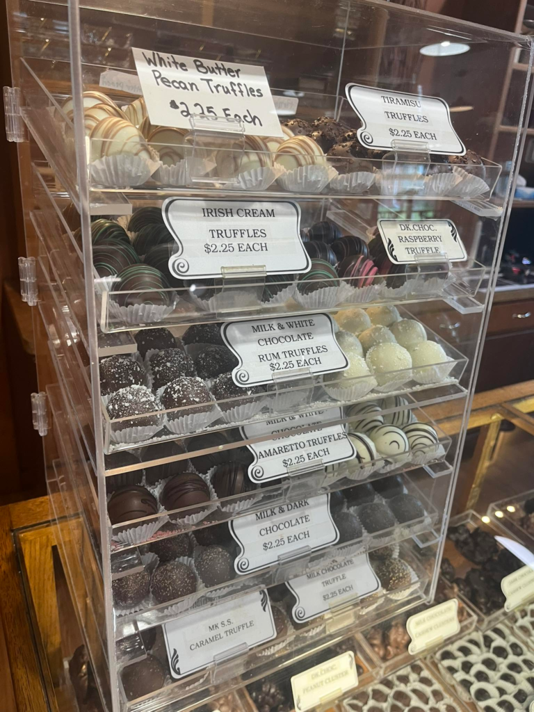 A display case of handmade truffles and chocolates.