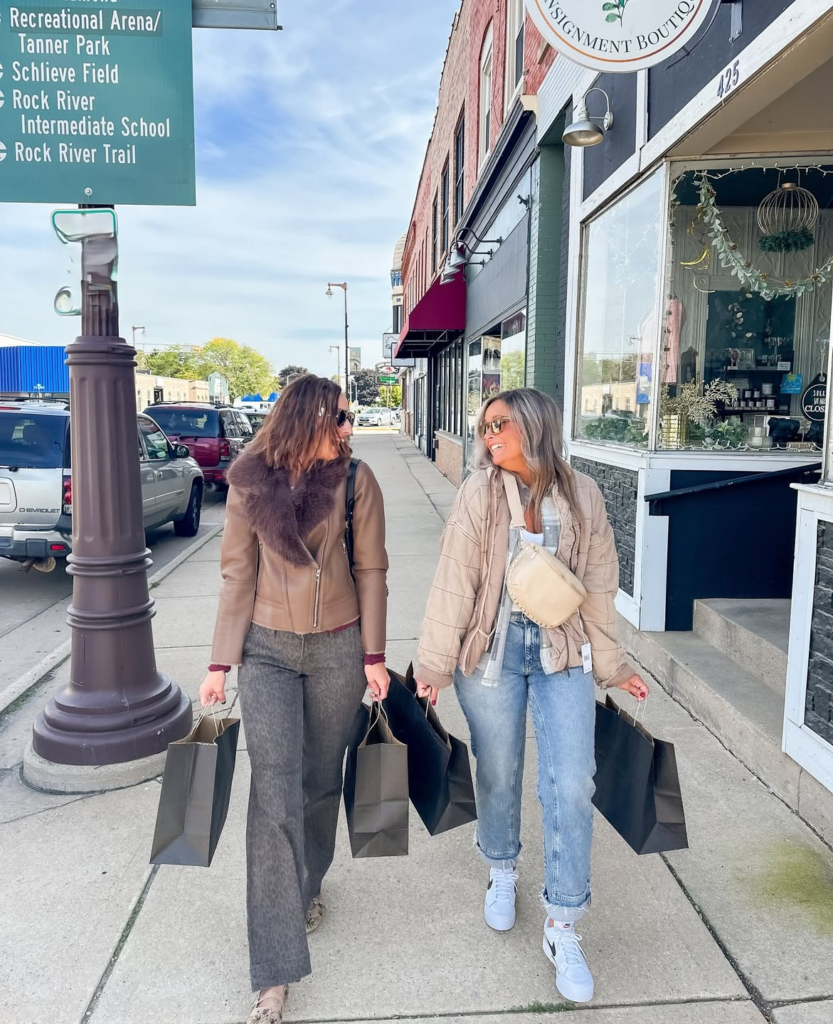 Two friends strolling a downtown Waupun sidewalk.