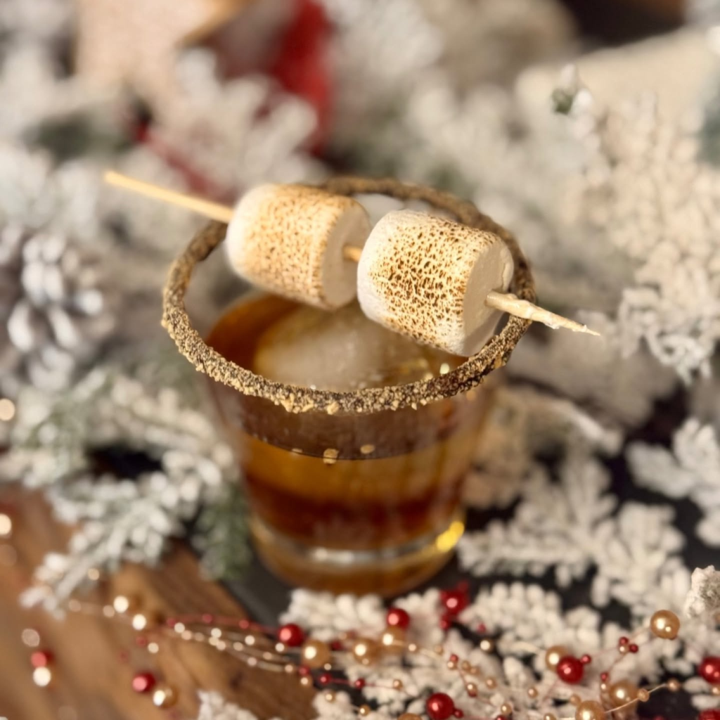 A cozy holiday drink topped with toasted marshmallows.
