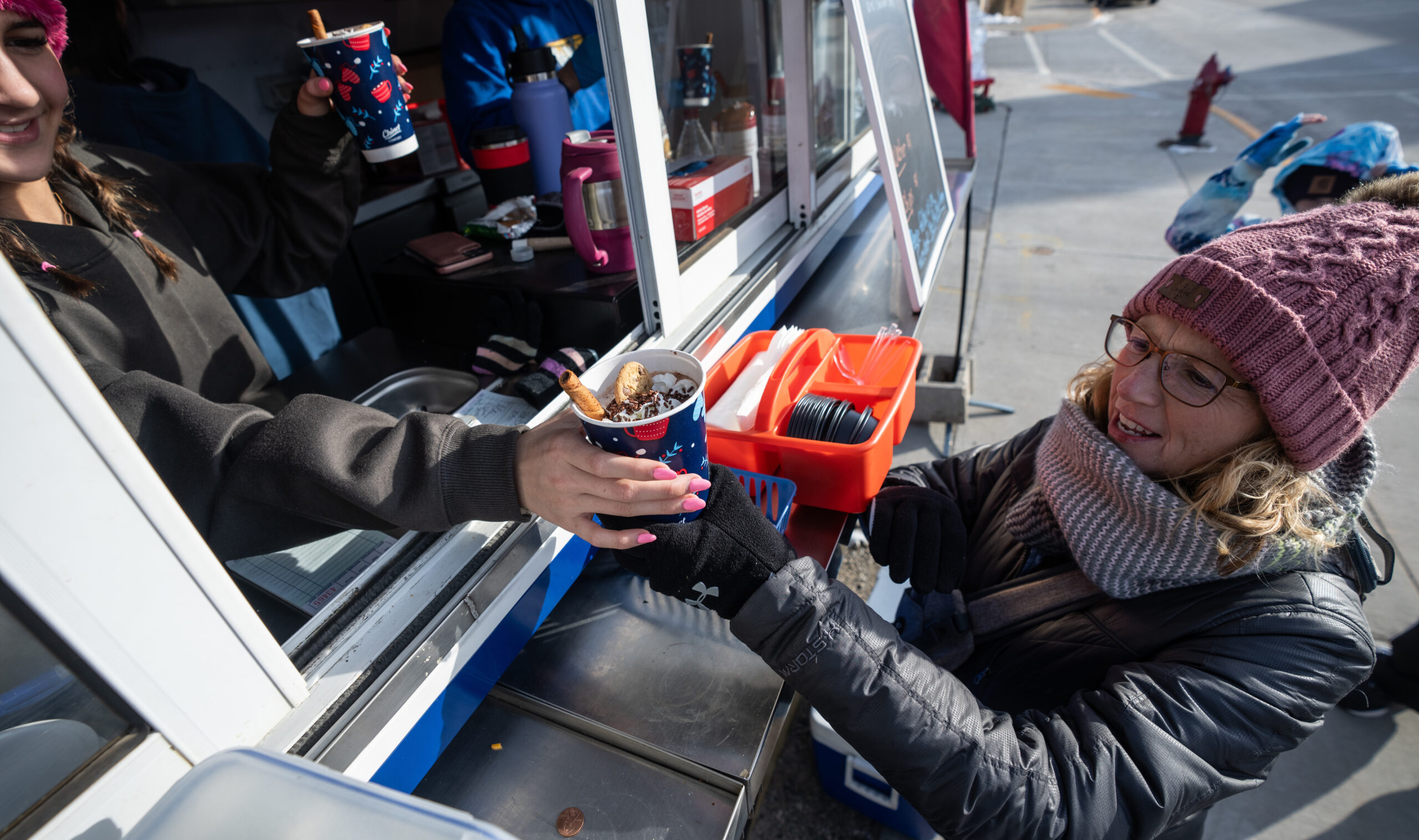 Visitors picking up treats at a winter booth.