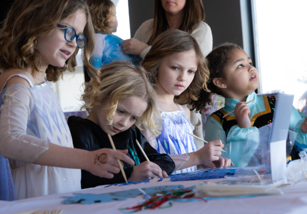 Kids making crafts together at a community event.