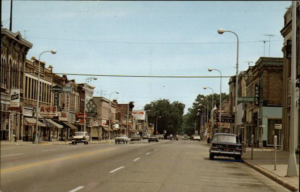 A vintage color postcard of Main Street in Waupun.